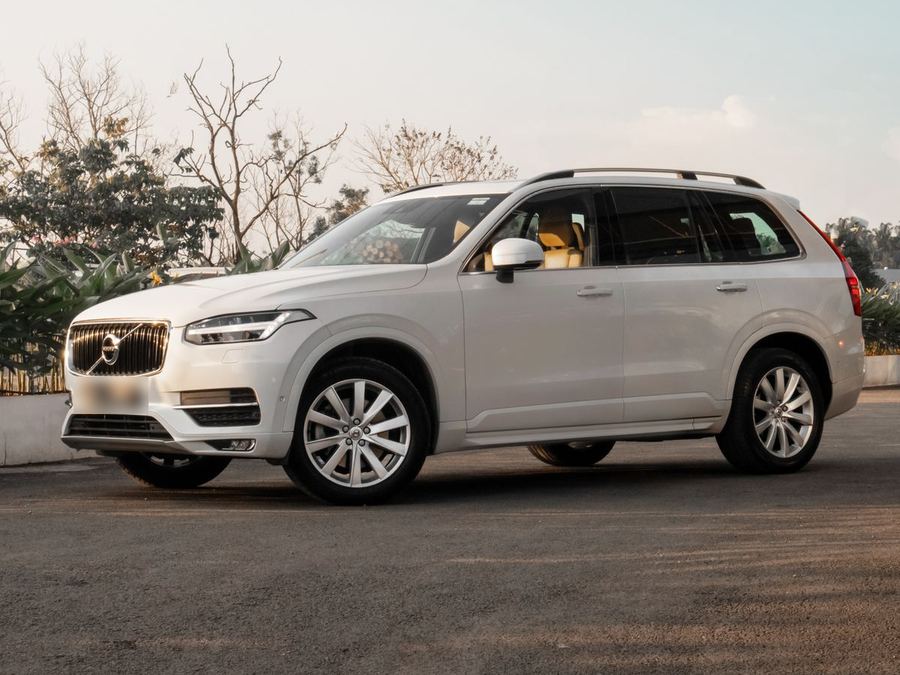 White family SUV parked at sunset
