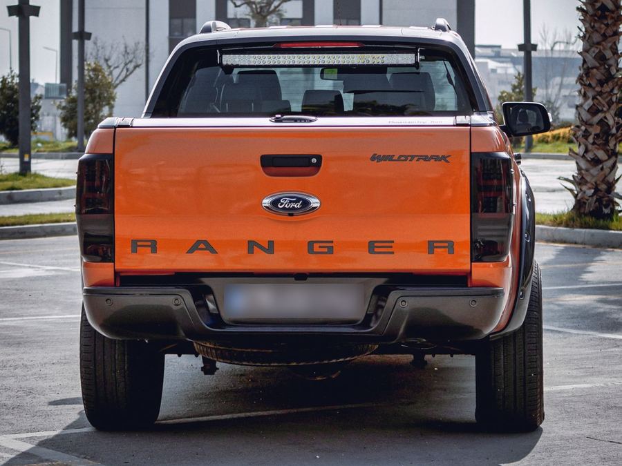 Orange ute seen from behind